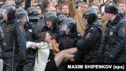 Russian riot policemen detain a demonstrator during the opposition rally in central Moscow on March 26.