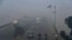 Commuters drive in heavy smog conditions in Lahore on November 21. 