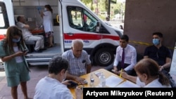 ARMENIA -- People prepare to get vaccinated against the coronavirus disease (COVID-19) at a mobile vaccination center in Yerevan, July 19, 2021