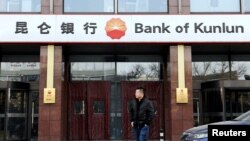 A man walks past a Bank of Kunlun branch in Beijing, China January 12, 2017. FILE PHOTO