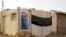 A poster on the home in Basra, Iraq, of Dhia Mutashar Gatie al-Issawi, an Iraqi who was fighting on behalf of the Syrian government before he was killed in Damascus.
