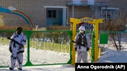 Armed police block an area around the school in Sosnovy Bor on the outskirts of Ulan-Ude after the attack on January 19.