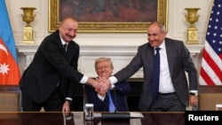 U.S. President Donald Trump holds the hands of Azerbaijan's President Ilham Aliyev and Armenia's Prime Minister Nikol Pashinyan during a trilateral signing event at the White House, Washington, August 8, 2025.