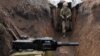 UKRAINE -- A Ukrainian serviceman walks in a trench as he stands at his post on the frontline with Russia backed separatists near the town of Zolote, in the Luhansk region, April 8, 2021