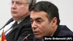 Macedonian Foreign Minister Nikola Dimitrov (front) speaks at a news conference with Greece's Nikos Kotzias.