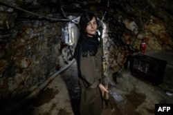 A female Iranian Kurdish fighter photographed in a tunnel in Iraq, near the border with Iran, on March 8.