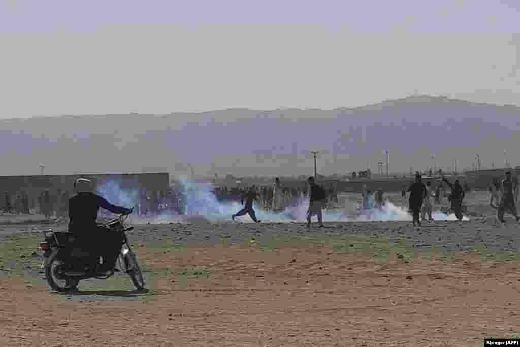 Pakistani security forces use tear gas to disperse displaced Afghans who were gathering at the Pakistani border on August 12. Many Afghans want to get to the Pakistani city of the Chaman border crossing, but it was closed after the Taliban took control of the Kandahar side.