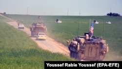 A convoy of U.S. army troops and the People's Protection Units (YPG) Kurdish militia patrol near Syrian-Turkish border in 2017