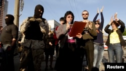 Pro-Russian protesters take part in a rally near the seized office of Ukraine's state security service in Luhansk late last month. 