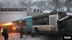 Emergency workers attend the scene of a deadly bus crash that occurred on December 25 after the vehicle lurched off a road and onto steps leading into an underground passageway in the Russian capital, Moscow.