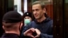 Aleksei Navalny gestures to his wife from inside a glass cell during a court hearing in Moscow in February 2021.