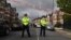 British police officers secure a cordon in a residential street in northwest London on April 28.