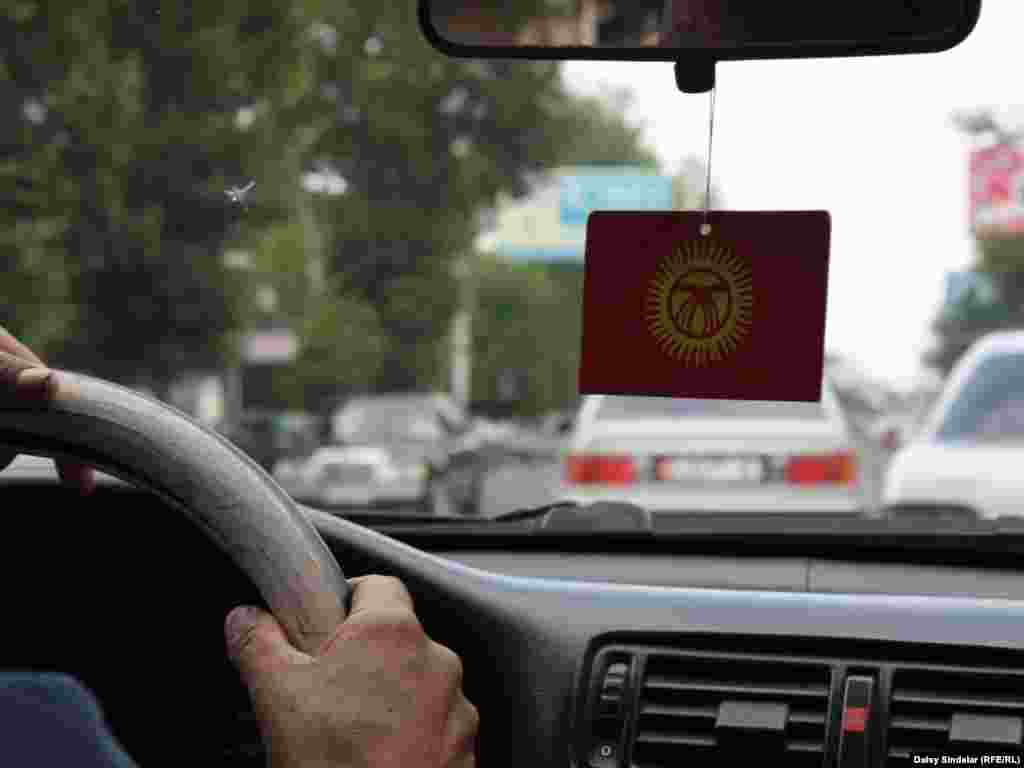 No, it’s not an air freshener, it's the Kyrgyz flag. A growing number of Kyrgyz taxi drivers in the southern city of Osh have been decorating their car with the flag.