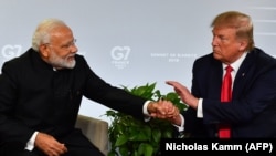 Indian Prime Minister Narendra Modi (L) and U.S. President Donald Trump shakes hands as they speak during a bilateral meeting in Biarritz on, August 26.