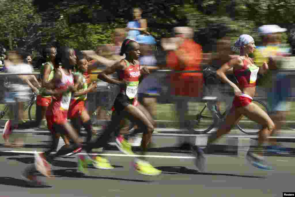 Jemima Jelagat Sumgong (center) brought Kenya its first-ever gold medal in an Olympic women&#39;s marathon and its first gold of the Rio games. Sumgong finished with a winning time of 2 hours, 24 minutes, and 4 seconds. She was unfazed by a protester&#39;s attempt to jump onto the marathon course.&nbsp;