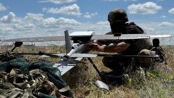 A soldier from Ukraine's 25th Separate Airborne Brigade prepares to launch a Hornet middle strike drone toward Russian troops from a position near a front line in the Donetsk region on June 23.