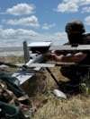 A soldier from Ukraine's 25th Separate Airborne Brigade prepares to launch a Hornet middle strike drone toward Russian troops from a position near a front line in the Donetsk region on June 23.