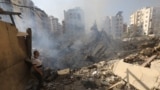 A man stands amid the rubble in Beirut's southern suburbs in the aftermath of Israeli air strikes.