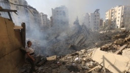 A man stands amid the rubble in Beirut's southern suburbs in the aftermath of Israeli air strikes.