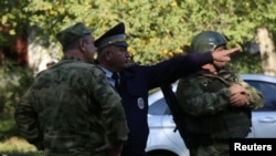 Law enforcement officers at the scene of a deadly shooting rampage at a college in the port city of Kerch.