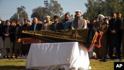 Afghans pray for TV anchor Malala Maiwand, who was shot and killed by gunmen soon after she left her house early on December 10.