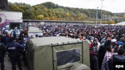 Refugees wait at the Slovenian-Austrian border in Spielfeld on October 23. 