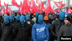 Far-right protesters march with faces covered during their annual march, which coincides with Poland's national Independence Day in Warsaw.
