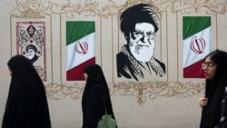 Women walk by a mural depicting Iran's late Supreme Leader Ayatollah Ali Khamenei in Tehran earlier this week. 
