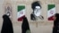 Women walk by a mural depicting Iran's late Supreme Leader Ayatollah Ali Khamenei in Tehran earlier this week. 