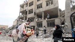 Iran - A family gathers the remaining furniture from an apartment damaged by an airstrike, Tehran, March 12, 2026.