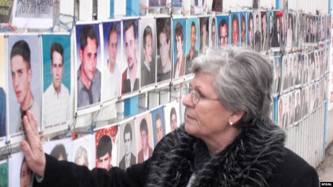 A photo of Nesrete Kumnova's son, Albion, is among the more than 300 such photos of the "not found" hanging on a fence outside the Kosovar parliament.