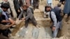 دفن اجساد افرادیکه در اثر سیلاب اخیر در چاریکار جان باختند.