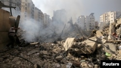 A man walks on the rubble of damaged buildings in the aftermath of Israeli air strikes on Beirut's southern suburbs in Lebanon on September 28.