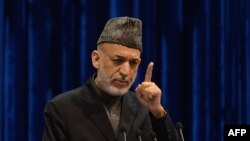 Afghan President Hamid Karzai addresses the Loya Jirga, a meeting of tribal elders and leaders, in Kabul on November 24.