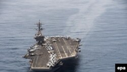 An aerial handout imge made available by US Navy showing the aircraft carrier USS Theodore Roosevelt operating in the Arabian Sea on 21 April 2015 conducting maritime security operations. 