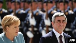 German Chancellor Angela Merkel and Armenian President Serzh Sarkisian inspect a military honor guard in Berlin on June 22.