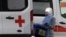 A medical staff member wearing a protective suit walks near a hospital where coronavirus patients are being treated in Moscow on March 17.