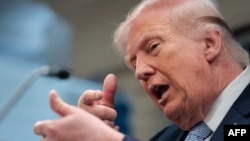US President Donald Trump mimics firing a gun as he speaks about the conflict in Iran at the White House on April 6. 