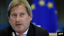 Johannes Hahn told European lawmakers that if Belgrade "is moving towards accession, the signal will have to be the right one" on sanctions against Russia.