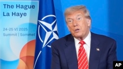 US President Donald Trump talks to reporters at the NATO summit in The Hague this week. 