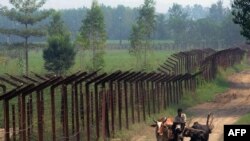 An Indian farmer on a cart passes along the line of control in Kashmir. (file photo)