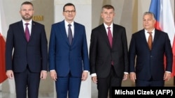 (Left to right:) Slovak Prime Minister Peter Pellegrini, Polish Prime Minister Mateusz Morawiecki, Czech Prime Minister Andrej Babis and Hungarian Prime Minister Viktor Orban pose for photo at the start of a Visegrad summit in Prague on September 12. 