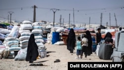 Families carry their belongings at the Kurdish-run Al-Khol camp, which holds relatives of suspected Islamic State fighters in Syria.