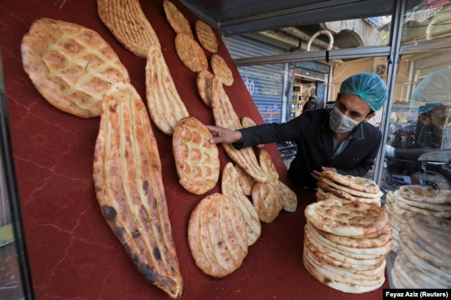 A man arranges naan bread to sell from a stall in Peshawar, Pakistan.