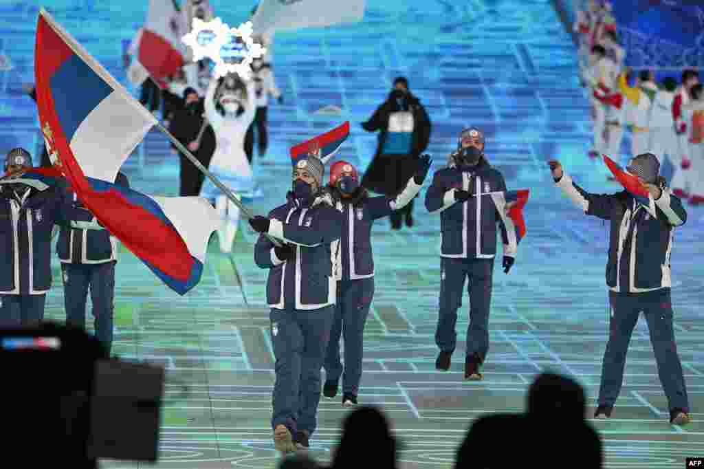 Serbian flag bearer Marko Vukicevic (left) leads the delegation during the opening ceremony of the Beijing 2022 Winter Olympic Games at the National Stadium, known as the Bird&#39;s Nest, in Beijing on February 4.