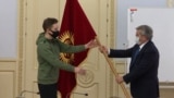 Maksim Gordeev receiving flag of Kyrgyzstan for 2022 Winter Olympics