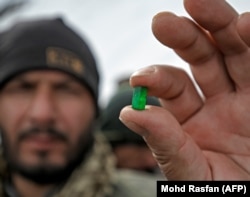 A miner shows off a freshly discovered emerald.