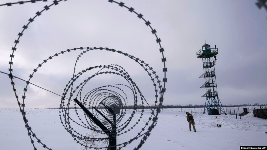 A Ukrainian guard patrols the border with Russia not far from the village of Hoptivka in the Kharkiv region on February 2.