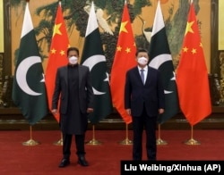 Pakistani Prime Minister Imran Khan (left) meets with the Chinese president on the sidelines of the Olympics on February 6.