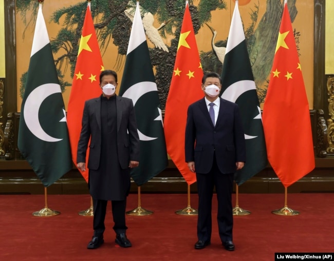 Pakistani Prime Minister Imran Khan (left) and Chinese President Xi Jinping meet in Beijing on February 6. - investment 